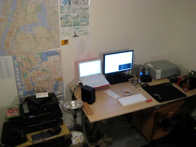 This picture is clicked inside the room. In this picture, we see a table on which laptop, speaker,...